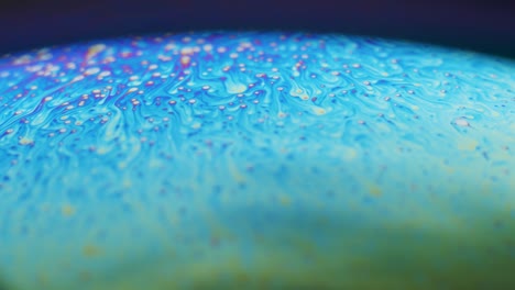 fluid dynamics and light refraction diffraction in soap bubble surface close up