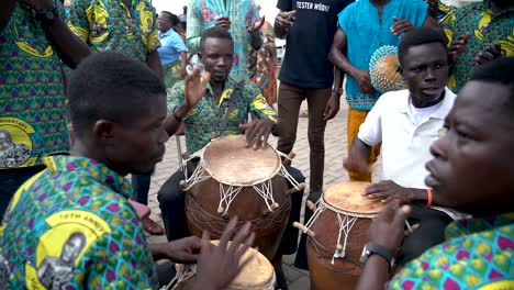 A close up slow motion shot shows a group of drummers pounding their drums for the Yam Festival in Ho, Ghana, West Africa.