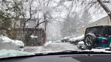 car driving through snow fall in a winter day - medium shot