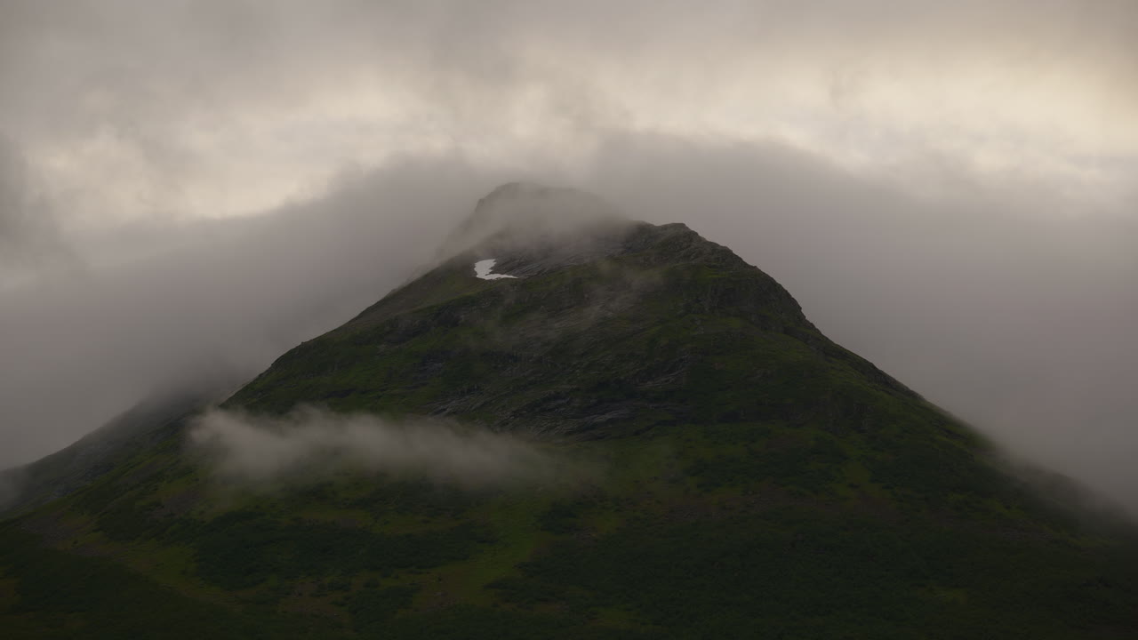 Clouds covering the mountain peak in Sunnmøre, Norway