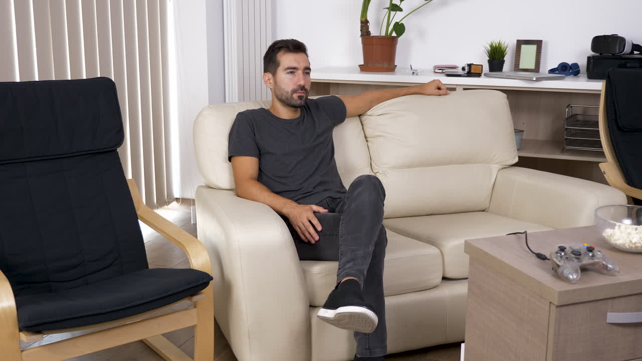Man Relaxing on Couch with Game Controller
