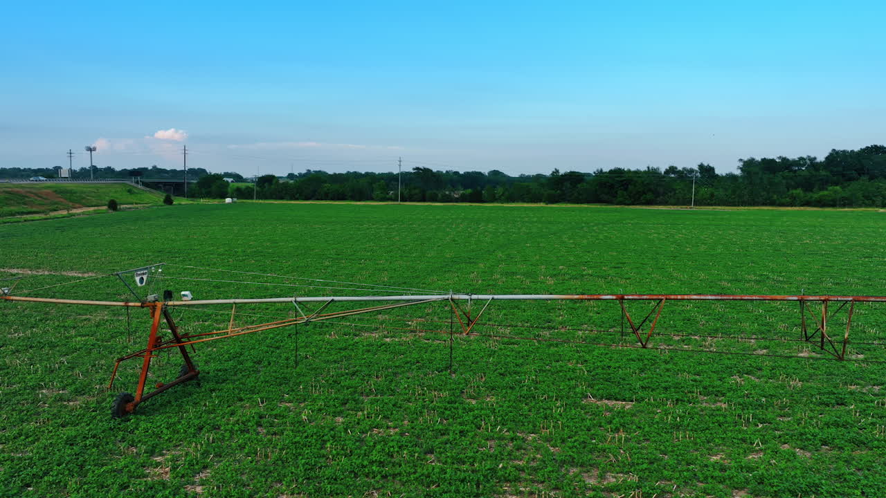 Movable metal construction for watering plants on the field. Center-pivot-irrigation system on the circular farm.