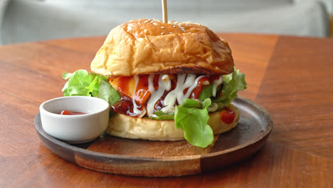 beef-burger-with-cheese-and-sauce-on-wood-plate