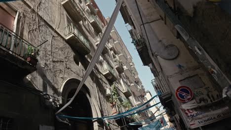 old city balconies on sunlit naples alley, italy