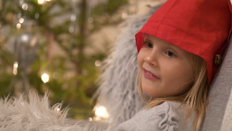 christmas portrait of sweet blonde girl on x-mas background, expressions of excitement and anticipation