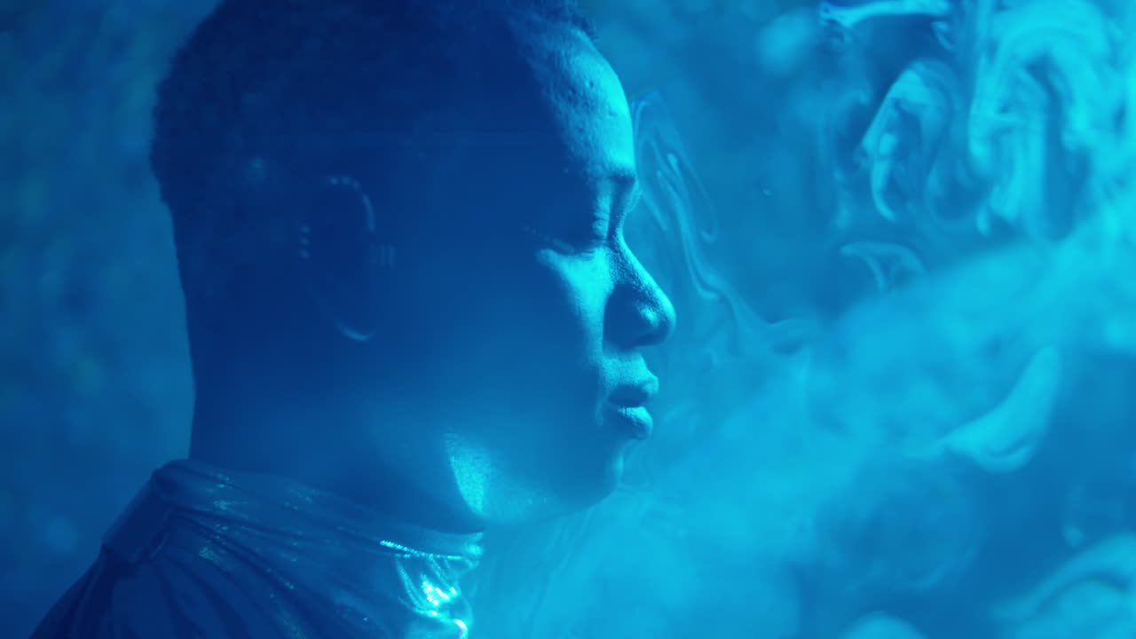 Man in Shiny Outfit Posing in Laser Light