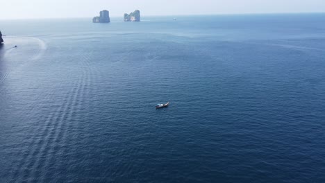 long tail boat, floating near tropical island, humid foggy misty morning