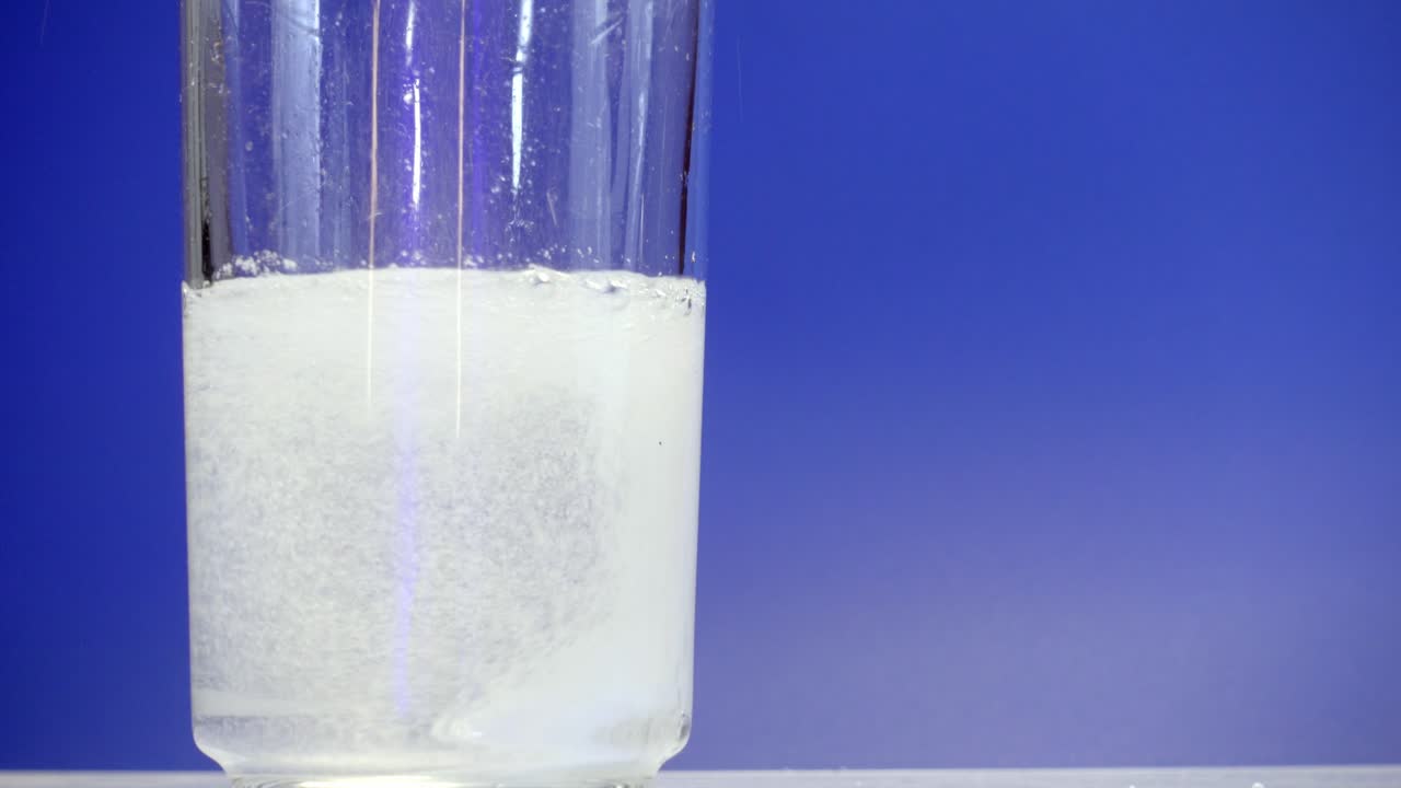 Effervescent Tablet Dissolving in Glass of Water Close-Up