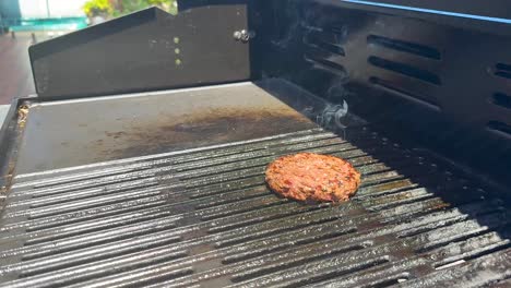 flipping burger with flames on barbecue grill