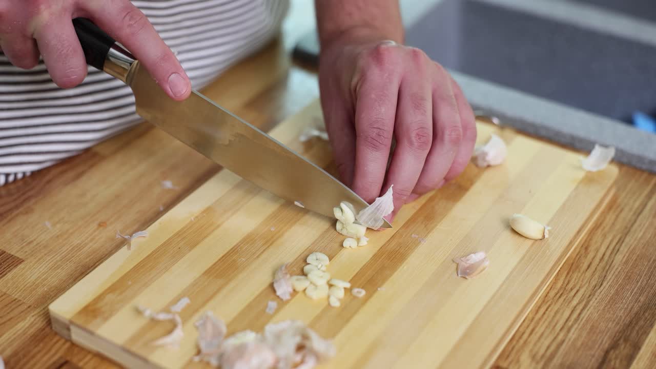 Cutting garlic on a wooden board