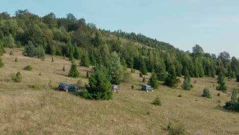 aerial view of four-wheel vehicles moving on rural serbian countryside landscape on sunny summer day, drone shot