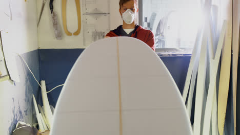 man making surfboard 4k