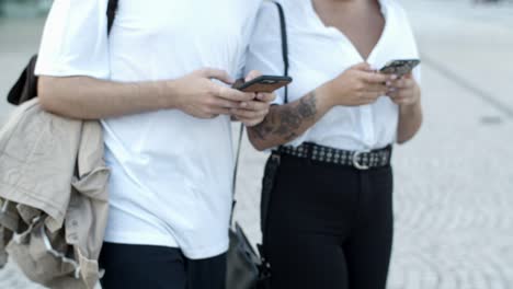 Cropped-shot-of-young-people-using-smartphones