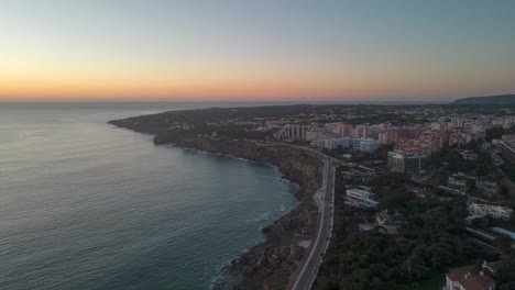 Timelapse-of-hell-mouth-at-sunset-over-city-in-Cascais,-Portugal