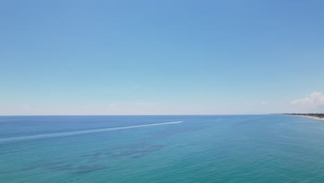 Boats-passing-by-water-Aerial-drone-view-of-west-palm-beach-skyline-downtown-area-and-beautiful-beach-sand-and-boats-in-water