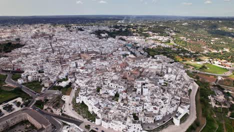 aerial orbit panorama of white old city ostuni in puglia italy, high angle