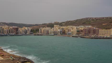 A-depiction-of-the-breathtaking-beauty-of-the-beachfront-apartments-in-Malta,-captured-in-a-captivating-time-lapse-video