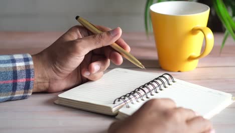 person taking notes at a desk