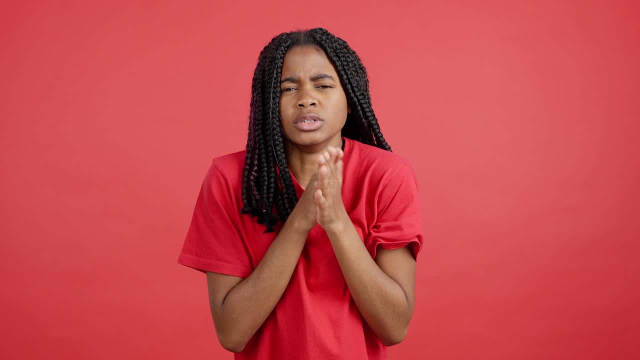 Woman in red with braids experiencing various ailments