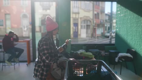 woman sorting laundry at laundromat