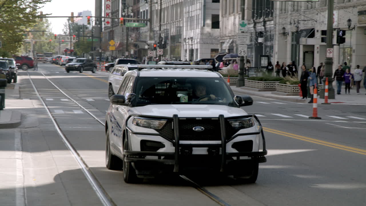 Detroit police car driving down Woodward Avenue in Detroit, Michigan.