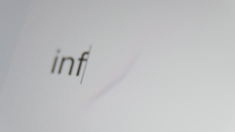 A close up of a digital screen showing a text cursor and "inflation" being typed