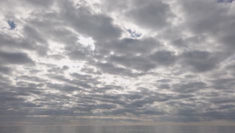 a cloudy sky over a calm atlantic ocean in the morning