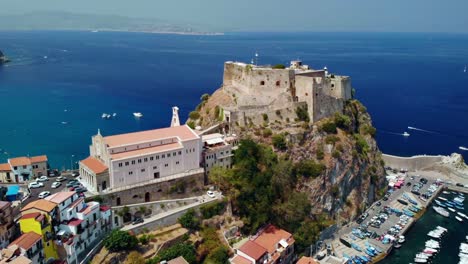aerial view of a coastal town in italy with a castle on a cliff