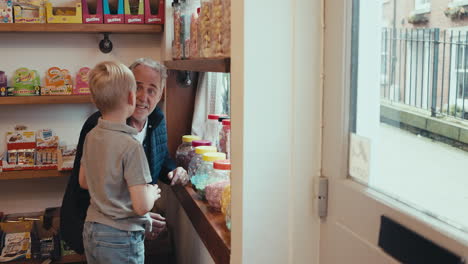 A grandfather and grandson in a vintage candy store