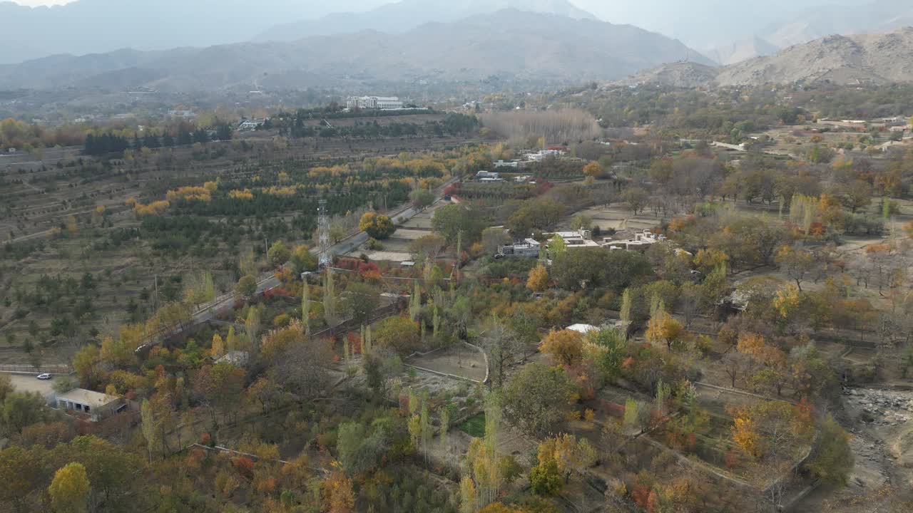 Aerial View of Paghman Afghanistan, Hillside Homes and Agricultural Fields on Misty Day, Drone Shot