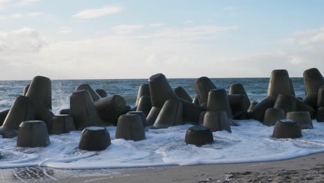 On-a-sunny-day-at-the-beach-of-Hörnum-waves-are-hitting-tetrapods-in-slow-motion