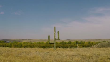 Wooden-hademade-cactus-in-a-country-field-on-a-sunny-day-with-a-blue-sky