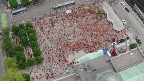 cinematic top down aerial of a huge crowd of protesters occupying a downtown city