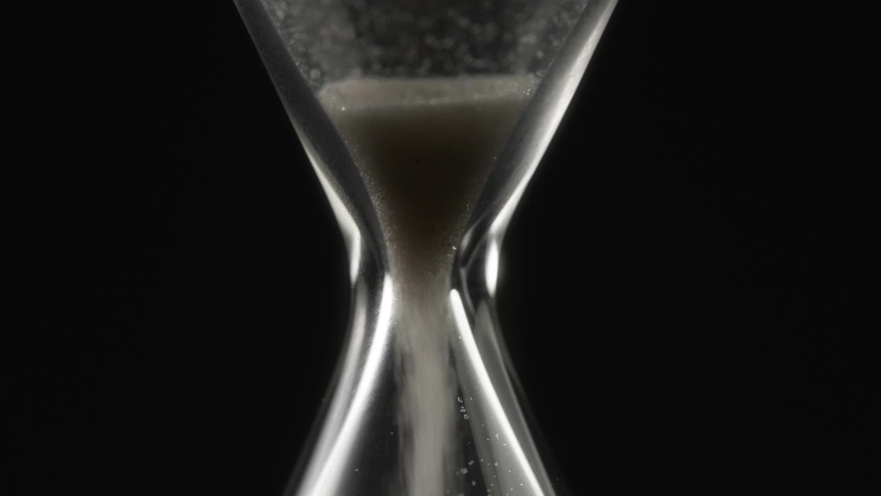Close-up of Sand Running Through a Glass Hourglass