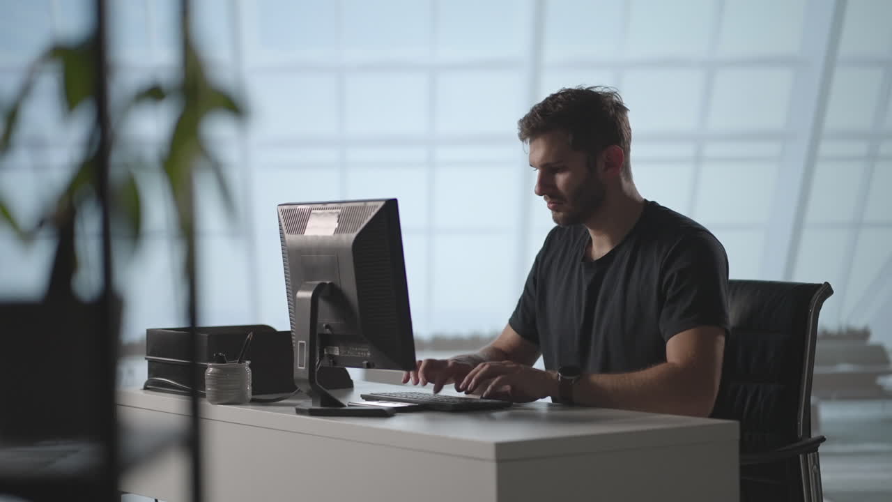 businessman working on computer at home office. Male professional typing on laptop keyboard at office workplace. Portrait of positive business man looking at laptop screen indoors
