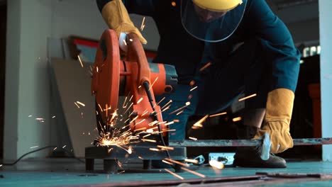 professional mechanic is cutting steel metal.