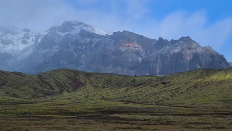 Icelandic-Landscape-Panorama,-Snow-Capped-Hills-and-Green-Wel-Fields-on-Cloudy-Day