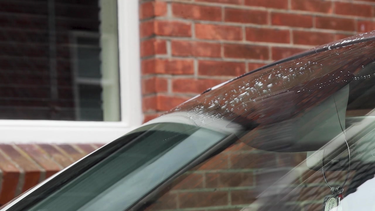 Video of windshield with washer fluid and wipers.