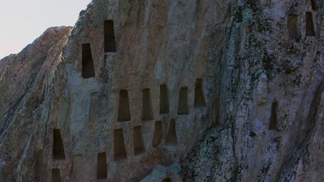 Retreating-drone-shot-Eagle's-Rock-or-more-known-as-Orlovi-Skali,-a-sacred-and-archeological-site-where-beehive-rock-formations-of-trapezoidal-niches-are-found-on-Rhodope-Mountain-in-Bulgaria