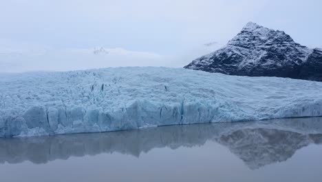 the wonderful glacier lagoon of fjallsárlón in iceland - aerial drone shot