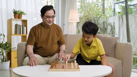 asian man and boy in the living room