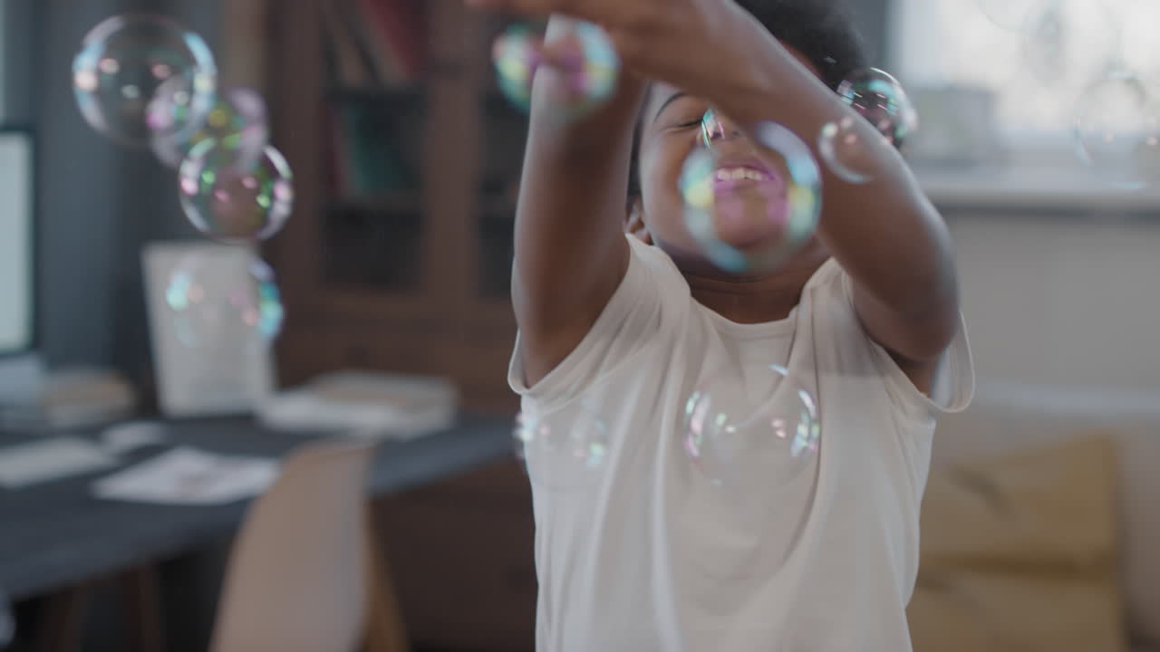 Happy Mixed-Race Kid Catching Soap Bubbles