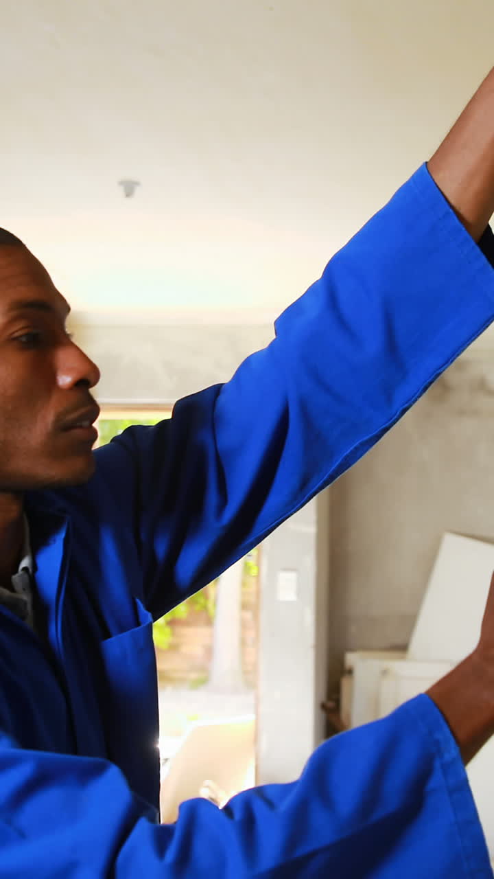 Repairman using measuring tape