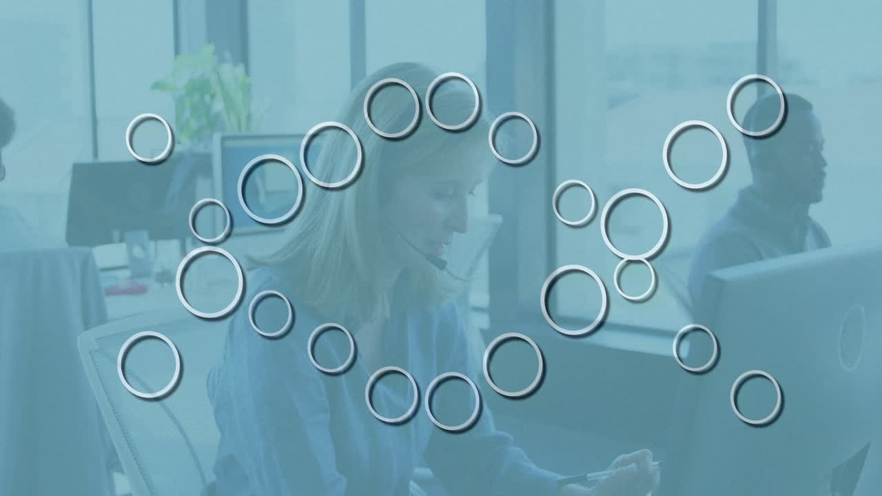 Working at desk, businesswoman analyzing data with circular animation overlay