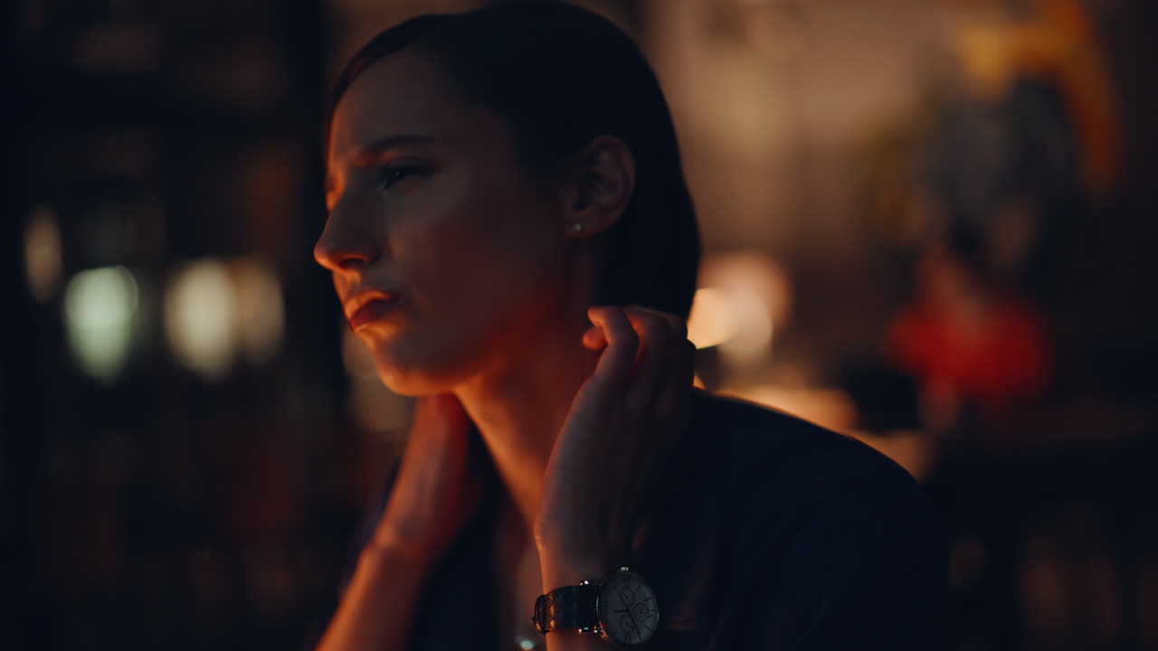 Overtime specialist massaging neck at dark office closeup. Tensed businesswoman