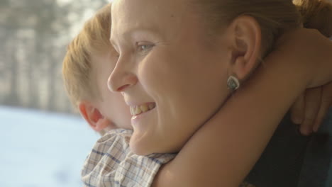 little child embracing mother in train