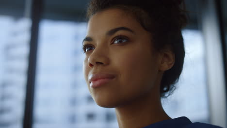 Afro-businesswoman-face-in-office.-Smiling-professional-drinking-coffee-from-cup