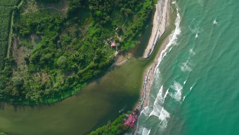 aerial view flying over river mouth and sea in la guajira, colombia