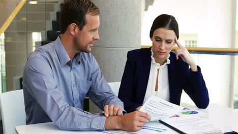 business colleagues discussing over document at desk 4k