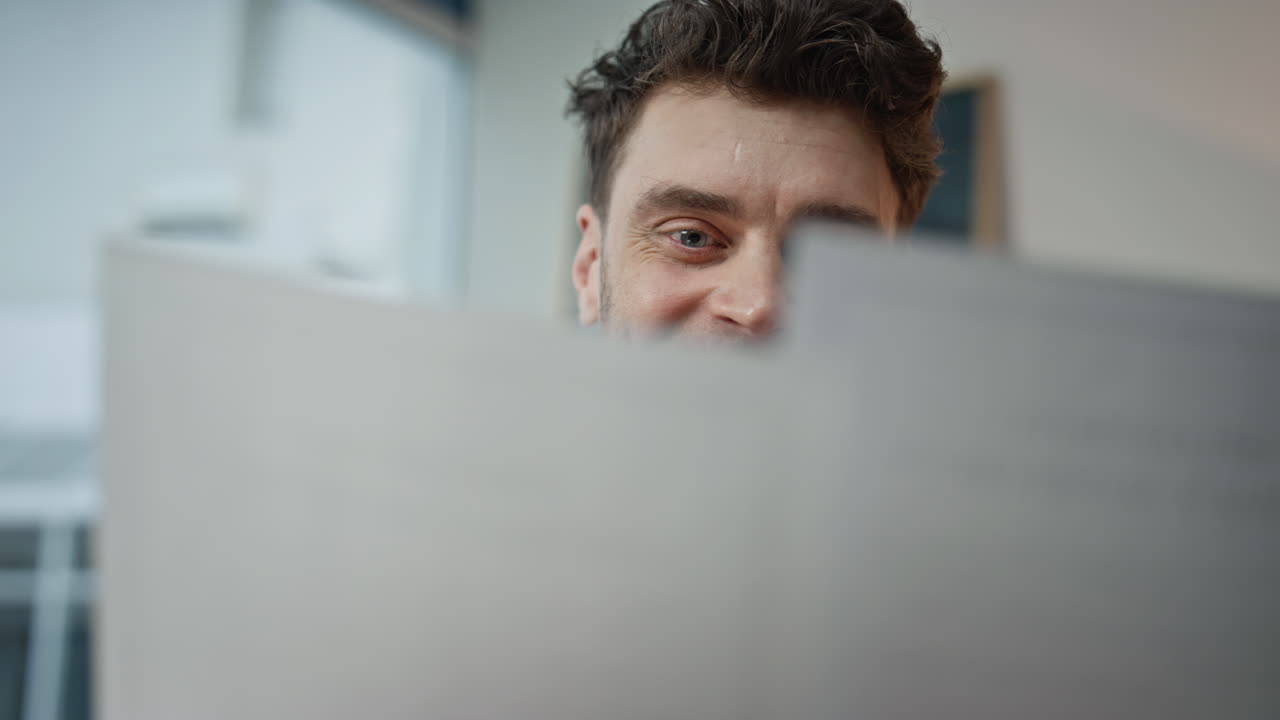 Satisfied employee reading report in office feeling success smiling closeup